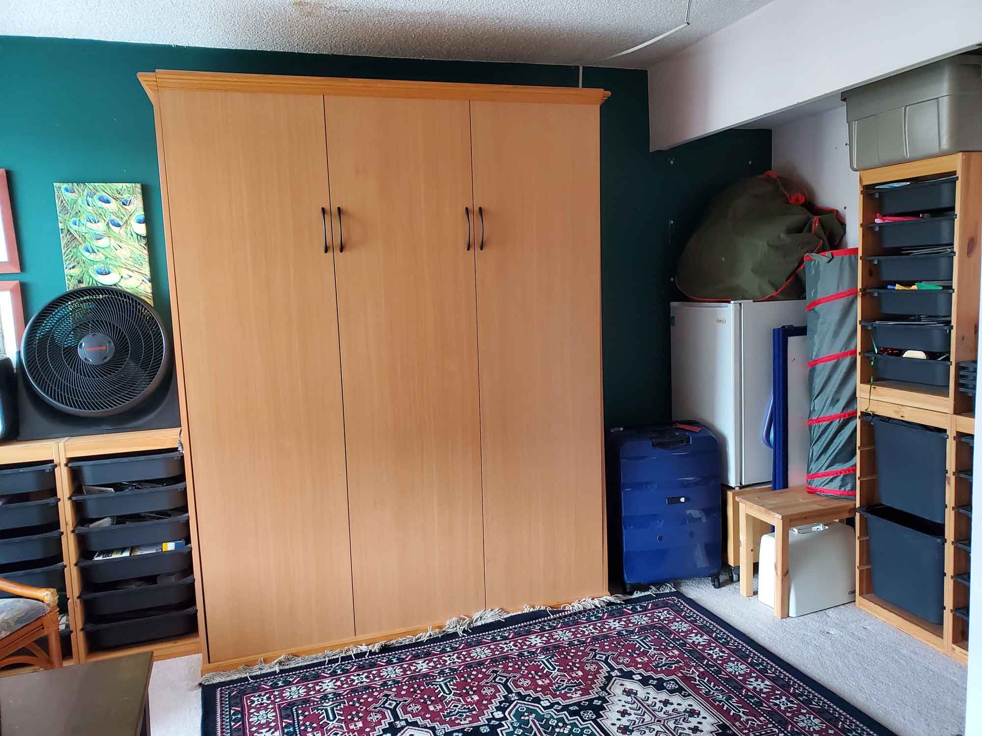 A fully-accessible murphy bed with items stacked neatly to the sides